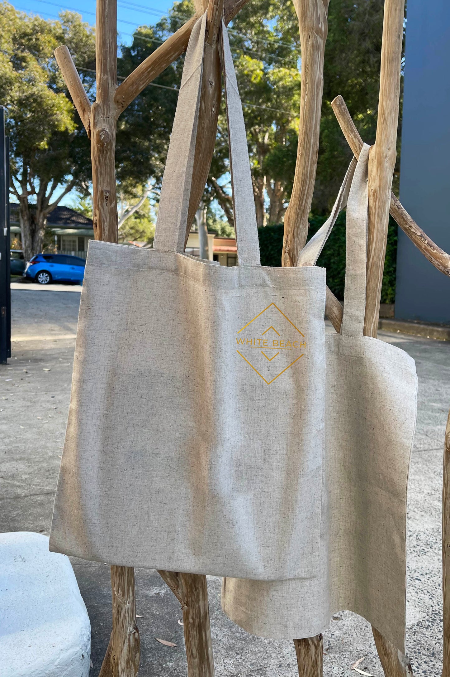 Beige hemp cotton blend tote bag with shoulder straps and logo.